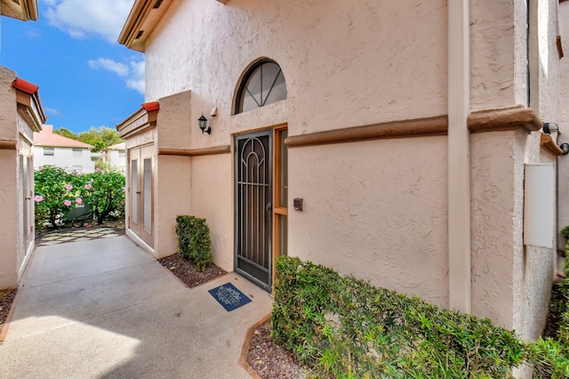 entrance to property with stucco siding