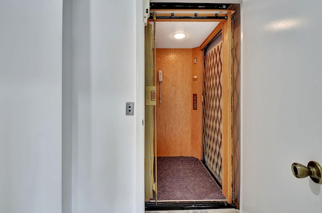 interior space with elevator and carpet flooring