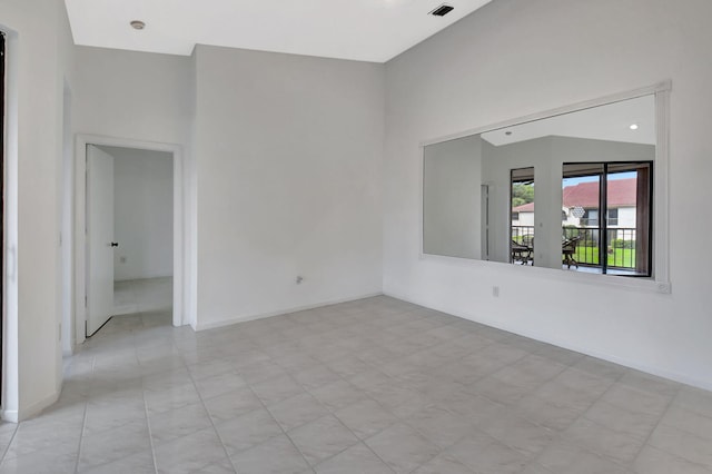 unfurnished room with baseboards and visible vents