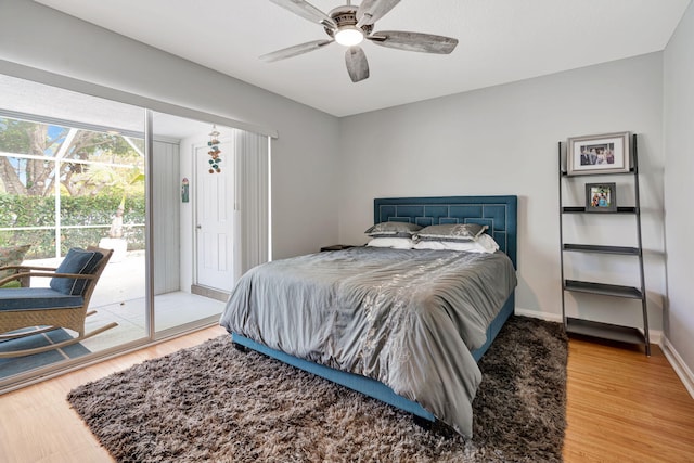 bedroom with access to exterior, a ceiling fan, baseboards, and wood finished floors