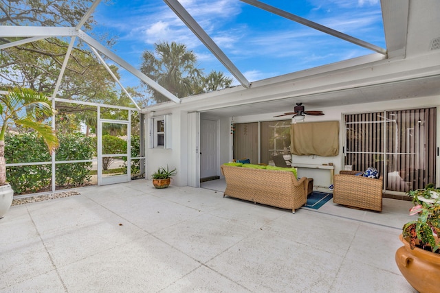 unfurnished sunroom with ceiling fan