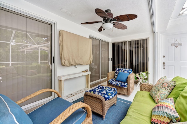 interior space featuring visible vents, a ceiling fan, and a textured ceiling