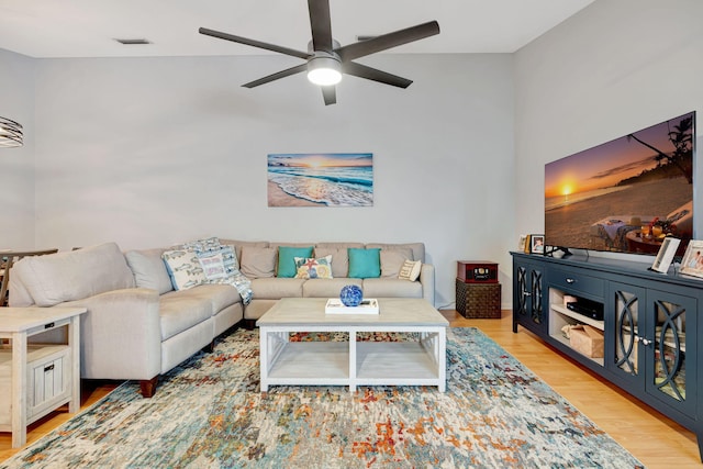 living area featuring visible vents, ceiling fan, and wood finished floors