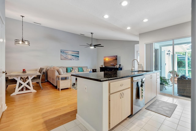 kitchen with decorative light fixtures, open floor plan, a sink, an island with sink, and dishwasher