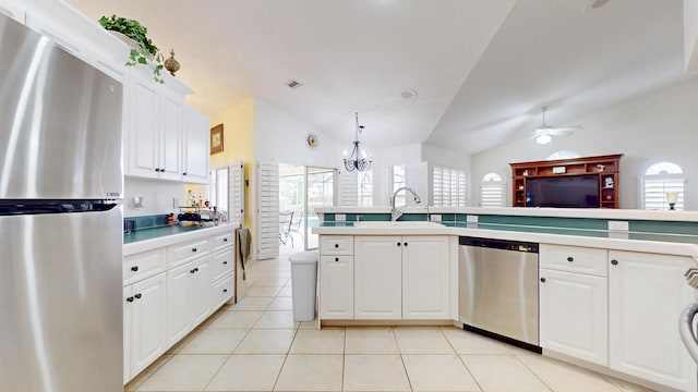 kitchen with stainless steel appliances, light countertops, white cabinetry, a sink, and light tile patterned flooring