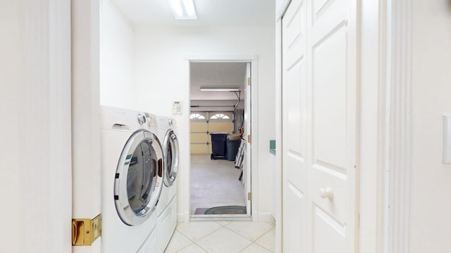 washroom with laundry area, washing machine and dryer, and light tile patterned floors