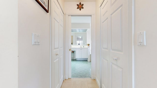 hallway featuring light tile patterned floors