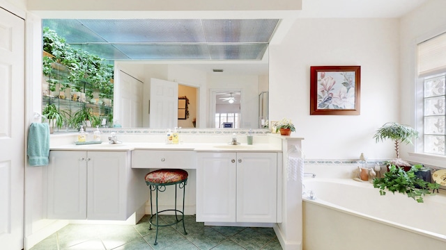 bathroom with tile patterned flooring, double vanity, a sink, and a bath