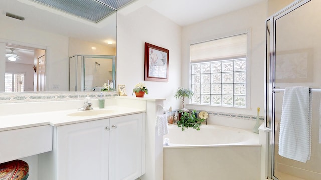 bathroom featuring a shower stall, visible vents, a bath, and vanity