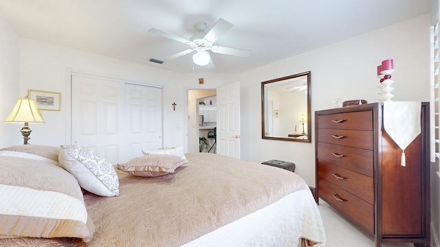 bedroom with a closet, visible vents, and a ceiling fan