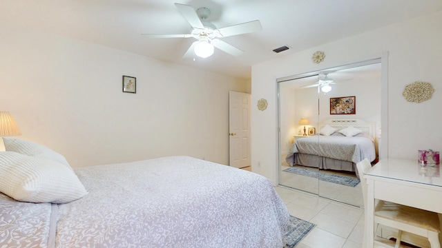 bedroom featuring a closet, visible vents, ceiling fan, and light tile patterned floors