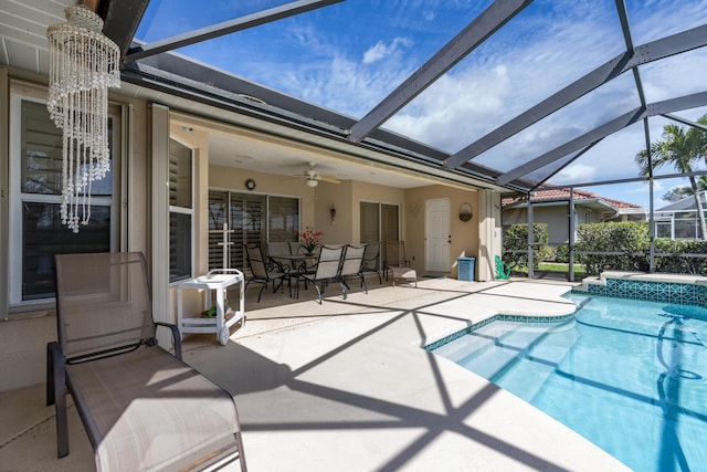pool with a lanai, ceiling fan, and a patio