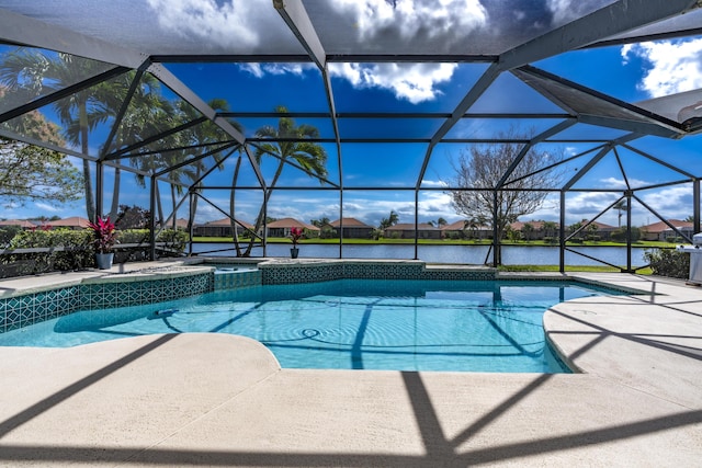 view of swimming pool featuring glass enclosure, a patio, a water view, and a pool with connected hot tub