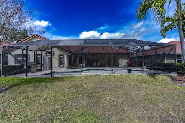 back of house with a yard, a patio, a lanai, an outdoor pool, and a tiled roof