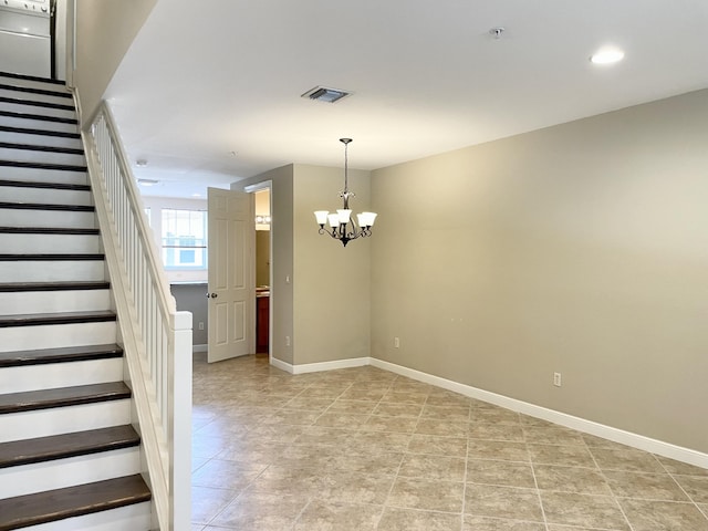 stairway with a notable chandelier, recessed lighting, visible vents, and baseboards