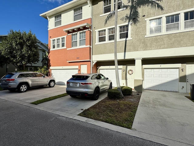 view of front of property with stucco siding, driveway, and an attached garage