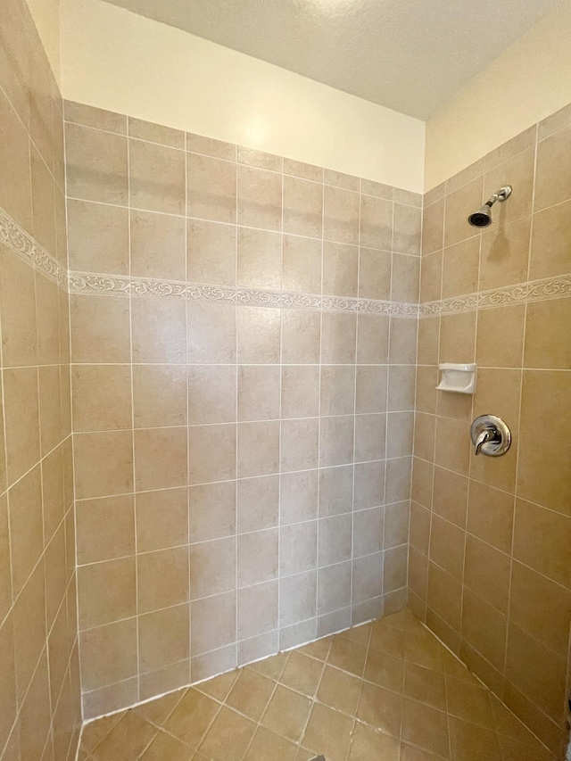 bathroom with a tile shower