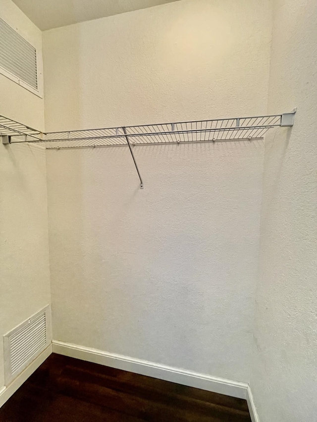 walk in closet featuring visible vents and wood finished floors