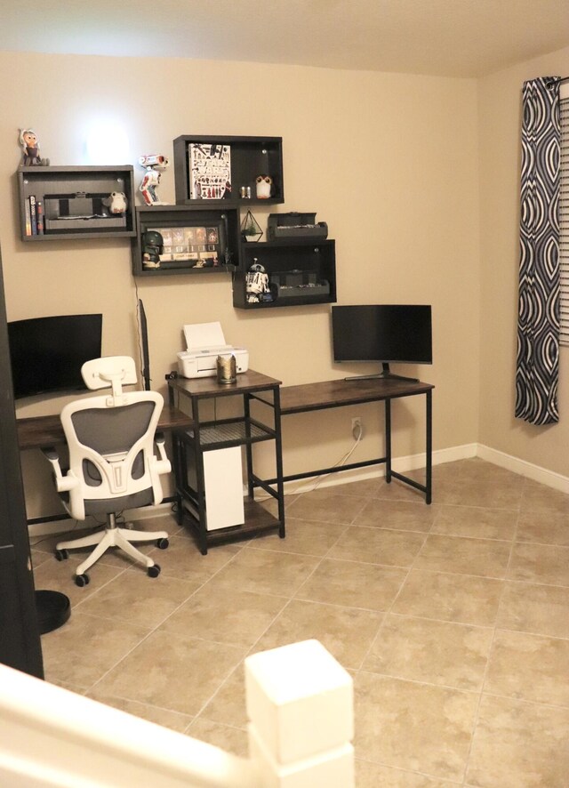 office space featuring baseboards and tile patterned floors