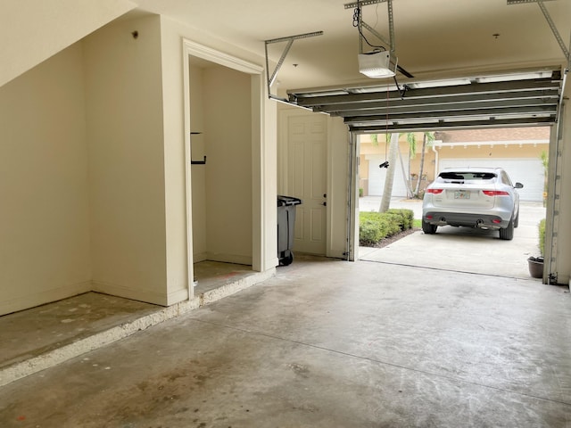 garage featuring baseboards and a garage door opener