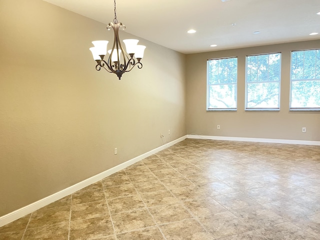 unfurnished room with a chandelier, recessed lighting, and baseboards