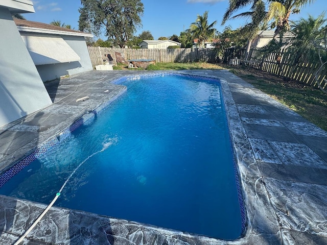 view of swimming pool with a fenced in pool and a fenced backyard