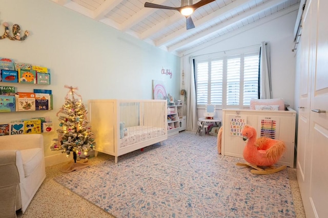 bedroom featuring lofted ceiling with beams, wood ceiling, speckled floor, and ceiling fan