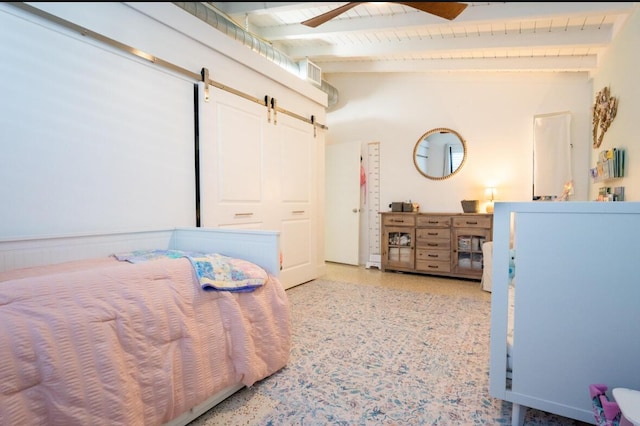 bedroom with visible vents, ceiling fan, a barn door, beam ceiling, and light speckled floor