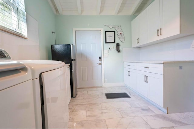 laundry room featuring washer and dryer, cabinet space, and marble finish floor