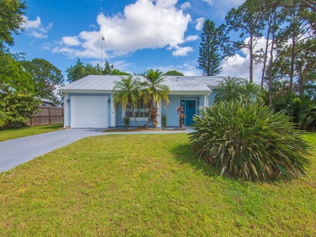 view of front of home featuring an attached garage, driveway, a front lawn, and fence