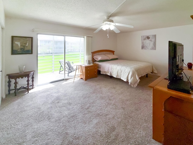 carpeted bedroom with access to exterior, ceiling fan, and a textured ceiling