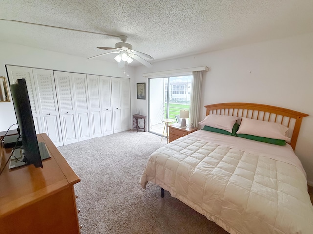 bedroom featuring a ceiling fan, light carpet, and a textured ceiling