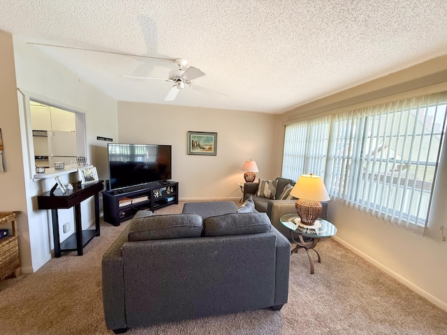 living room with carpet, a ceiling fan, and a healthy amount of sunlight