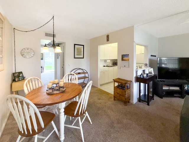 dining area featuring light carpet and visible vents