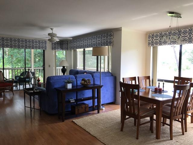 dining space featuring wood finished floors and a ceiling fan