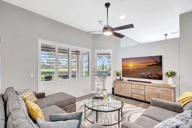 living area featuring light wood-type flooring, visible vents, and a ceiling fan