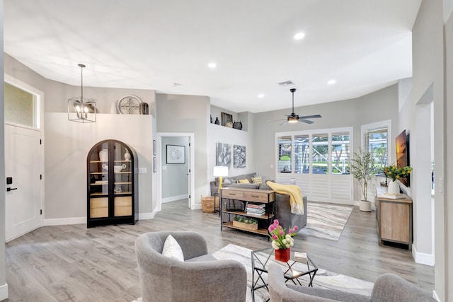 living room featuring light wood-style floors, baseboards, and recessed lighting