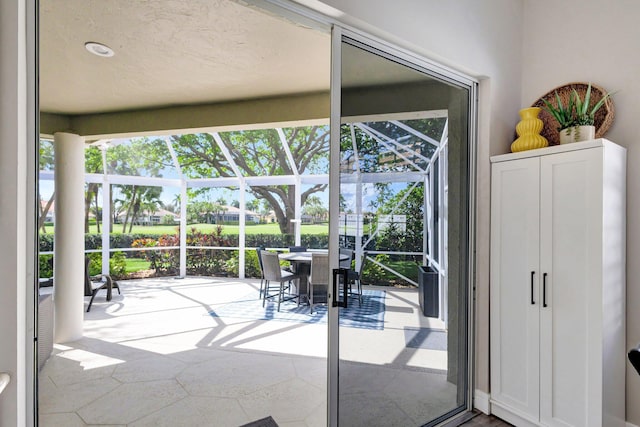 doorway to outside with plenty of natural light and a sunroom