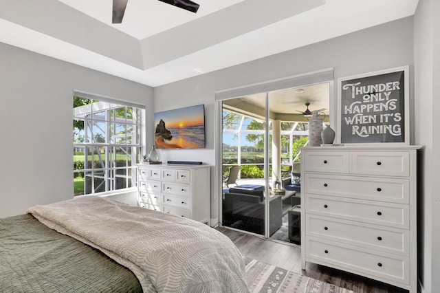 bedroom with access to exterior and wood finished floors