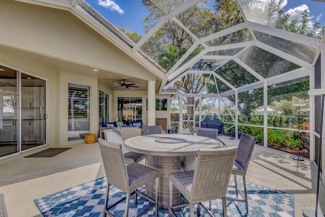 view of patio / terrace featuring a lanai, ceiling fan, and outdoor dining area