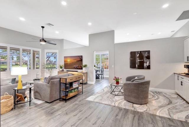 living area with light wood-style floors, recessed lighting, visible vents, and baseboards