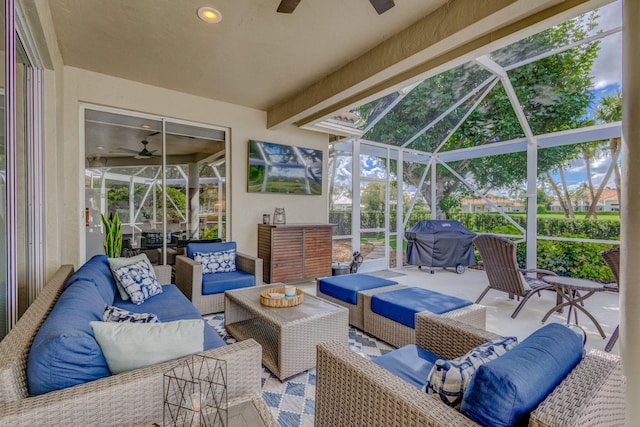 view of patio / terrace featuring glass enclosure, an outdoor hangout area, a ceiling fan, and area for grilling