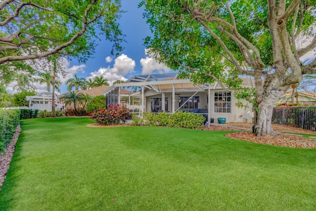 view of yard featuring a lanai and fence