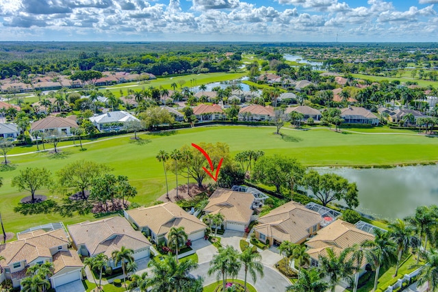 aerial view with a residential view, a water view, and golf course view