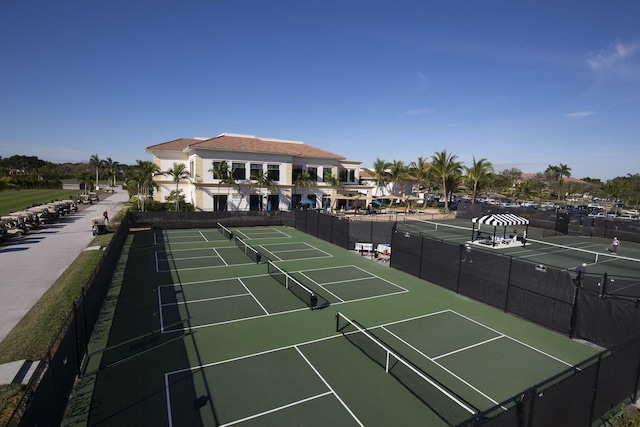 view of tennis court featuring fence