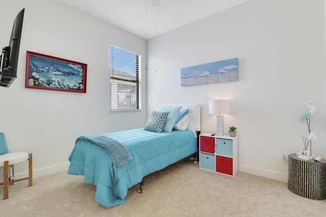 carpeted bedroom featuring baseboards