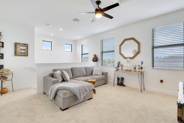 living room featuring light carpet, visible vents, and baseboards