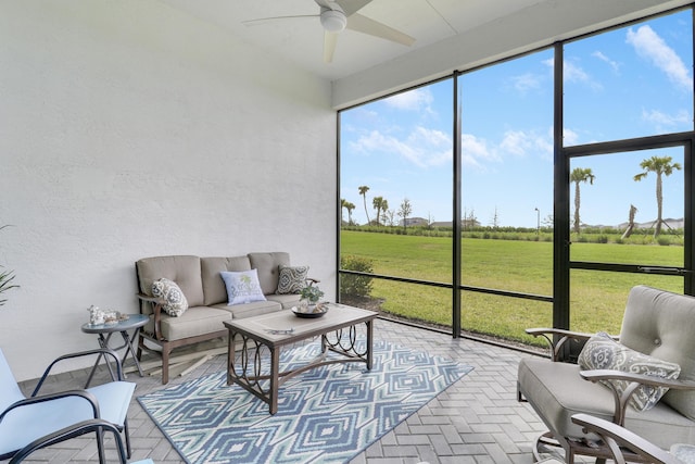 sunroom with a rural view and a ceiling fan