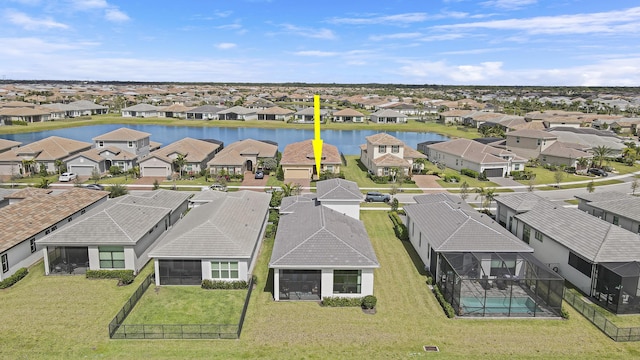 drone / aerial view with a water view and a residential view