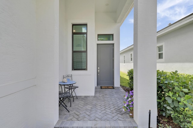 entrance to property featuring stucco siding